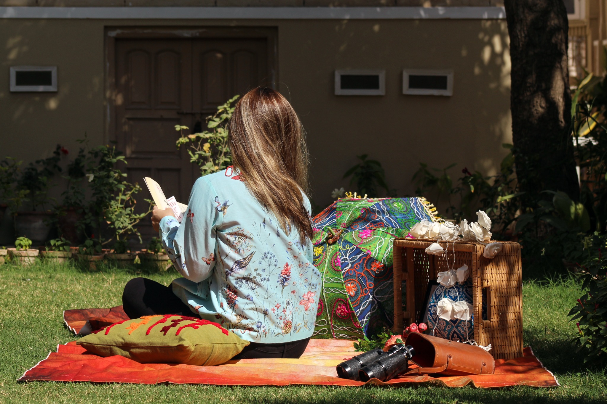 Baani final campaign lifestyle image with model reading outdoors